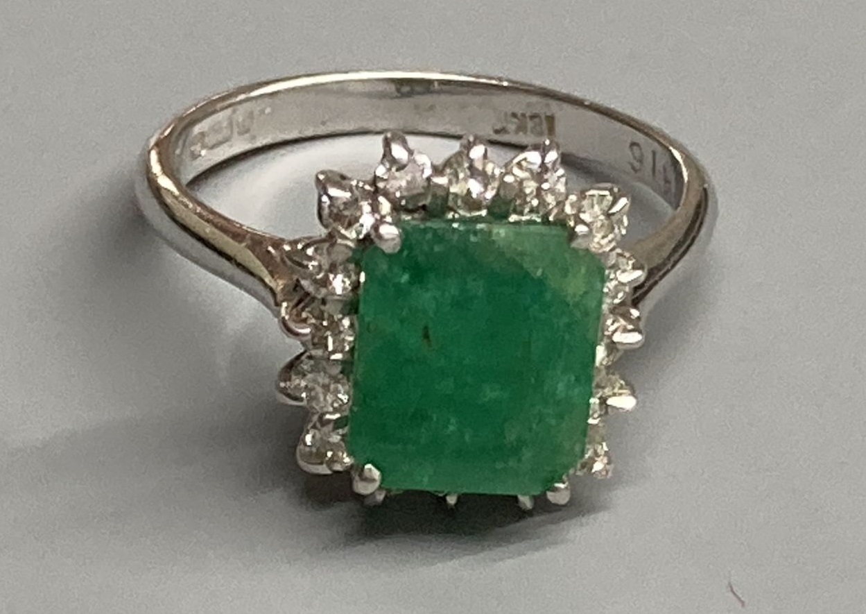 A modern 18ct white gold, emerald and diamond set rectangular cluster ring, size K, gross 3.4 grams.